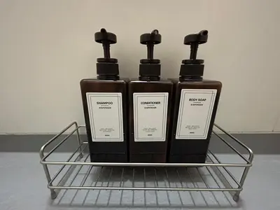 three bottles of soap sitting on a rack at NIYS apartments 0074 type in Tokyo