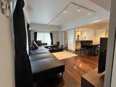 a living room with a couch and a dining room at NIYS apartments 0074 type in Tokyo