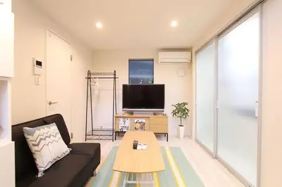 a living room with a couch and a tv at Building A101 / Vacation STAY 1275 in Tokyo