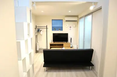 a living room with a couch and a television at Building A101 / Vacation STAY 1275 in Tokyo