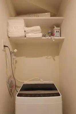 a white dishwasher in a small kitchen with towels at Building A101 / Vacation STAY 1275 in Tokyo