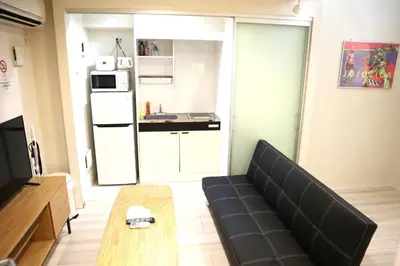 a living room with a couch and a kitchen at Building A101 / Vacation STAY 1275 in Tokyo