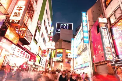 a crowd of people walking down a busy city street at night at Building A101 / Vacation STAY 1276 in Tokyo
