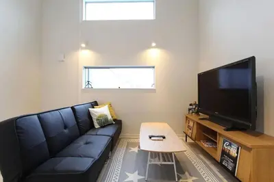 a living room with a couch and a flat screen tv at Building A101 / Vacation STAY 1276 in Tokyo