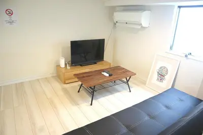 a living room with a television and a coffee table at Shibuya-ku - Apartment / Vacation STAY 1103 in Tokyo