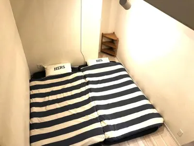 a bed in a room with two pillows on it at Shibuya-ku - Apartment / Vacation STAY 1103 in Tokyo