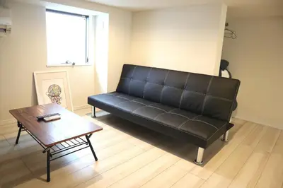 a black couch in a living room with a table at Shibuya-ku - Apartment / Vacation STAY 1103 in Tokyo