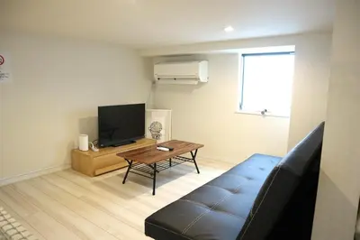 a living room with a couch and a tv at Shibuya-ku - Apartment / Vacation STAY 1103 in Tokyo