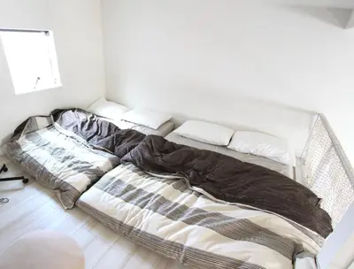 two unmade beds in a white room at Shibuya-ku - Apartment / Vacation STAY 1130 in Tokyo