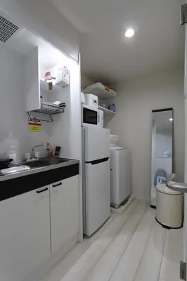 a white kitchen with a sink and a refrigerator at Shibuya-ku - Apartment / Vacation STAY 1130 in Tokyo