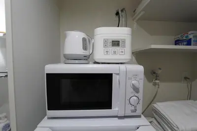 a microwave with a coffee maker on top of it at Shibuya-ku - Apartment / Vacation STAY 1130 in Tokyo