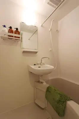 a bathroom with a sink and a green towel at Shibuya-ku - Apartment / Vacation STAY 1130 in Tokyo