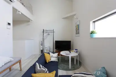 a living room with a blue couch and a table at Shibuya-ku - Apartment / Vacation STAY 1130 in Tokyo
