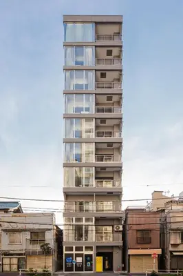 a tall building with balconies on the side of it at Hotel Apartment Ueno Inaricho Sta in Tokyo