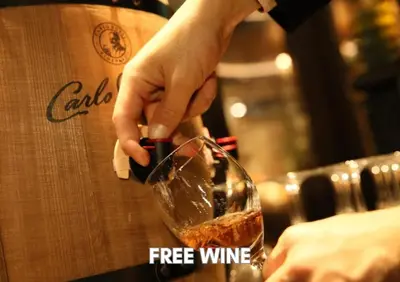a person is pouring wine into a wine glass at Hotel Pasela Living Shinjuku in Tokyo
