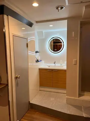 a bathroom with a sink and a mirror at City Hotel Southern Cross in Tokyo