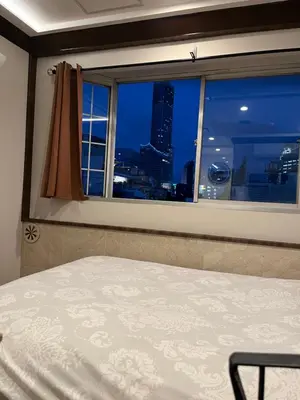 a bedroom with a window with a view of a city at City Hotel Southern Cross in Tokyo