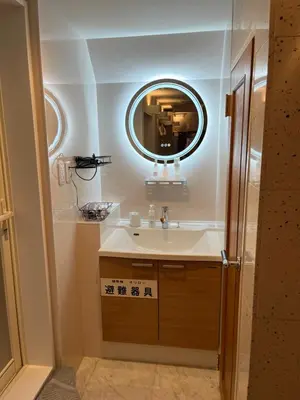 a bathroom with a sink and a mirror at City Hotel Southern Cross in Tokyo