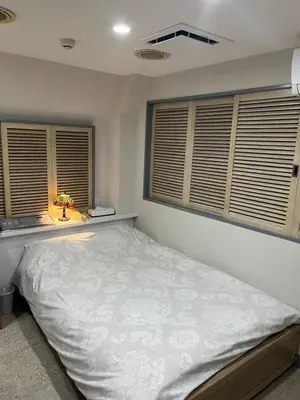 a bedroom with a bed and two windows at City Hotel Southern Cross in Tokyo