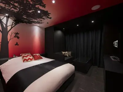 a bedroom with a bed and a tree on the wall at Hotel Crest Hirai (Adult Only) in Tokyo