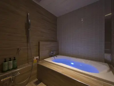 a bathroom with a bath tub and a shower at Hotel Crest Hirai (Adult Only) in Tokyo
