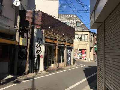 an empty street in an asian city with buildings at Etranger Kaname Cho in Tokyo