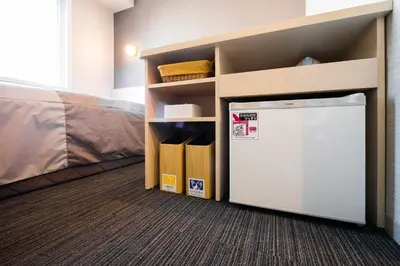 a closet with a refrigerator in a room at Super Hotel Tokyo JR Shinkoiwa in Tokyo