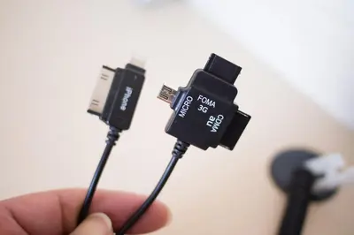 a person holding a usb cable in their hand at Super Hotel Tokyo JR Shinkoiwa in Tokyo