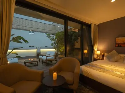 a hotel room with a bed and two chairs at Hotel Tokyo Trip Ueno Nishi Nippori in Tokyo
