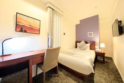 a hotel room with a desk and a bed at Hotel Tokyo Trip Ueno Nishi Nippori in Tokyo