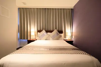a bedroom with a bed with white sheets and pillows at Hotel Tokyo Trip Ueno Nishi Nippori in Tokyo
