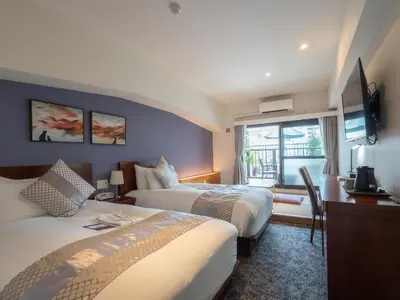 a hotel room with two beds and a window at Hotel Tokyo Trip Ueno Nishi Nippori in Tokyo
