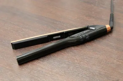 a black flashlight sitting on top of a wooden table at Hotel Tokyo Trip Ueno Nishi Nippori in Tokyo