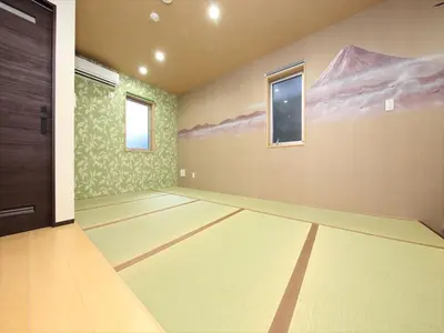 an empty room with a door and a painting on the wall at COTO Tokyo Nakano in Tokyo