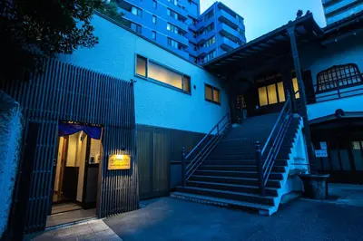 a blue building with stairs in front of a building at \u5bbf\u574a \u6b63\u4f1d\u5bfa Temple hotel Shoden-ji in Tokyo