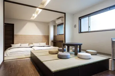 a bedroom with a bed and a table and a window at \u5bbf\u574a \u6b63\u4f1d\u5bfa Temple hotel Shoden-ji in Tokyo