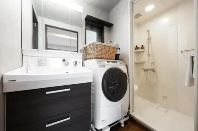 a bathroom with a washing machine and a sink at \u5bbf\u574a \u6b63\u4f1d\u5bfa Temple hotel Shoden-ji in Tokyo