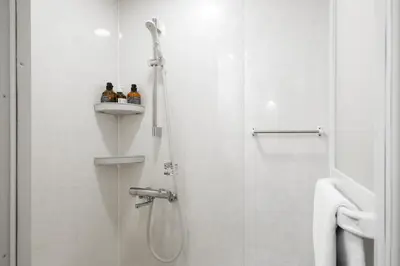 a shower with two bottles on a shelf in a bathroom at \u5bbf\u574a \u6b63\u4f1d\u5bfa Temple hotel Shoden-ji in Tokyo
