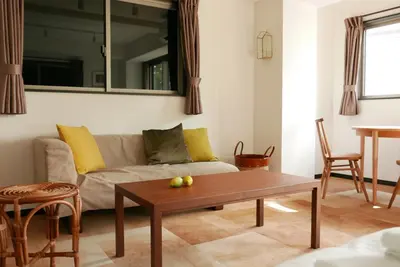 a living room with a couch and a table at Tokyo Sakurako Hatchobori in Tokyo