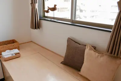 a room with a pillow and a window at Tokyo Sakurako Hatchobori in Tokyo