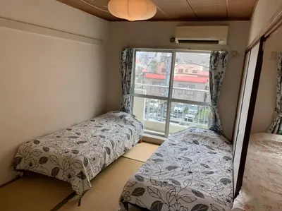 a small room with two beds and a window at Tokyo Stay House Otsuka --Kitchen-Living-dining-3room-- in Tokyo