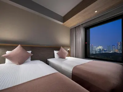a hotel room with two beds and a large window at Villa Fontaine Grand Tokyo Shiodome in Tokyo