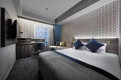 a hotel room with a bed and a desk at Villa Fontaine Grand Tokyo Roppongi in Tokyo