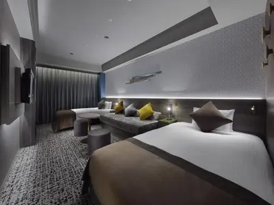 a hotel room with two beds and a couch at Villa Fontaine Grand Tokyo Roppongi in Tokyo