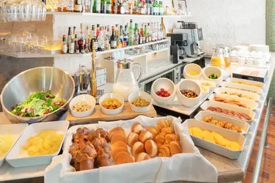 a buffet with many different types of food in trays at Villa Fontaine Grand Tokyo Roppongi in Tokyo
