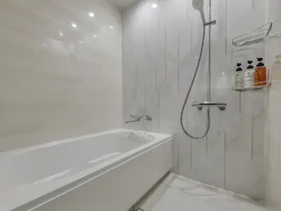 a white bathroom with a tub and a shower at Villa Fontaine Grand Tokyo Tamachi in Tokyo