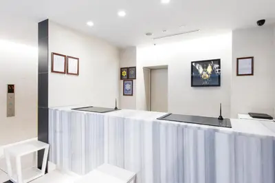 a waiting room with a long counter in a clinic at Villa Fontaine Tokyo Shinjuku in Tokyo