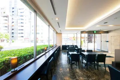 a restaurant with tables and chairs and large windows at Villa Fontaine Tokyo Otemachi in Tokyo