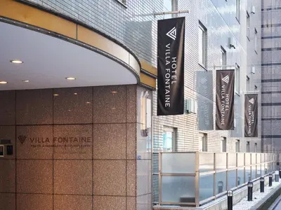a building with signs on the side of it at Villa Fontaine Tokyo Nihombashi Mitsukoshimae in Tokyo