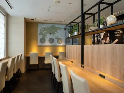 a dining room with a long table and white chairs at Villa Fontaine Tokyo Hatchobori in Tokyo